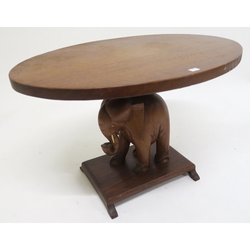 126 - A 20th century hardwood coffee table with carved elephant supports, oval occasional table with carve... 