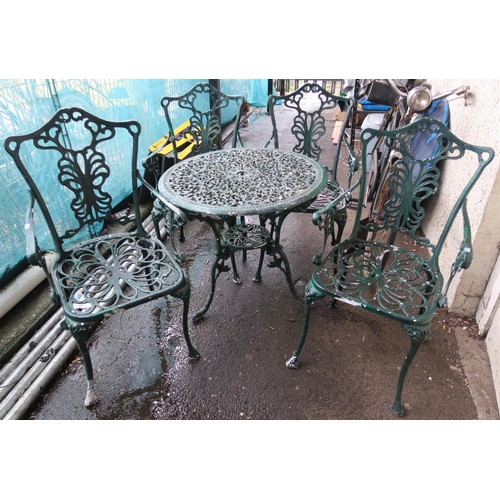 133 - A modern cast metal garden table and four chairs (5)