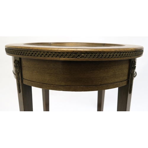 19 - A 20th century oak circular bijouterie table on square tapering supports, 73cm high x 49cm diameter