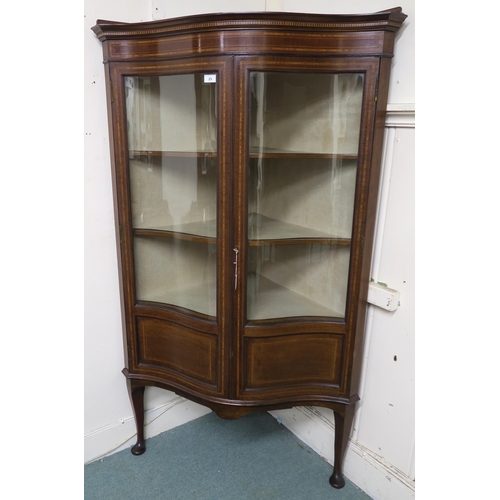 25 - An Edwardian mahogany glazed serpentine front corner cabinet on cabriole supports, 168cm high x 97cm... 