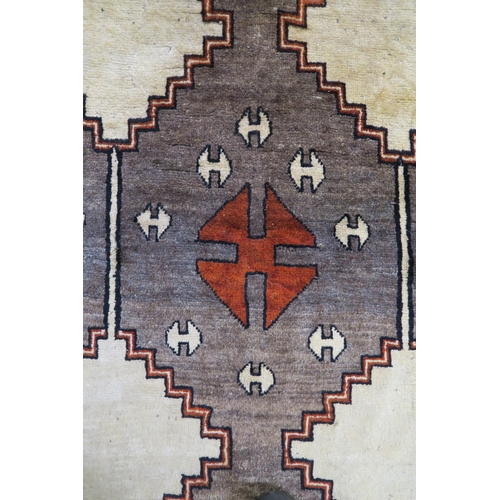 54 - A Shiraz rug with stylized horse head design 290cm x 206cm