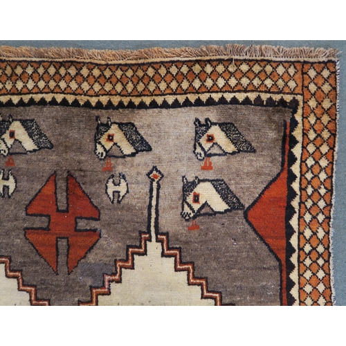 54 - A Shiraz rug with stylized horse head design 290cm x 206cm