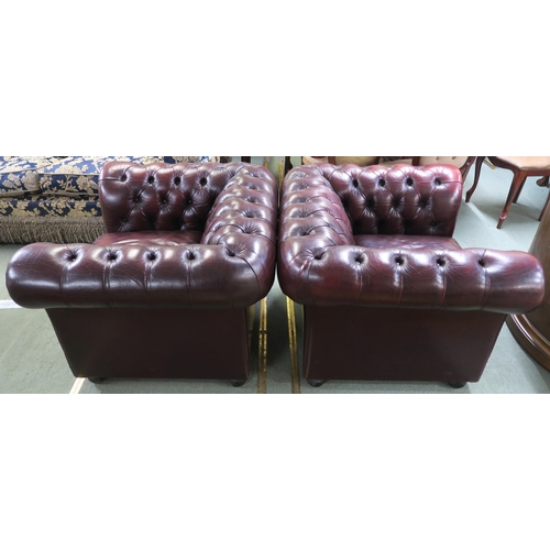 56 - A pair of contemporary oxblood leather upholstered chesterfield club chairs, 70cm high x 102cm wide ... 