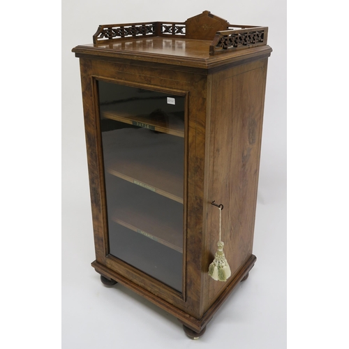 7 - A Victorian walnut glazed music cabinet with fretwork gallery top, 94cm high x 46cm wide x 38cm deep