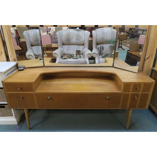 71 - A mid 20th century teak Meredew triple mirror dressing table with central drawer flanked by two draw... 