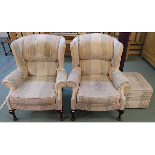 75 - A pair of 20th century upholstered wing back armchairs and a matching footstool (3)