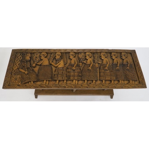 77 - A 20th century carved African hardwood coffee table with carved elephant supports, 43cm high x 122cm... 