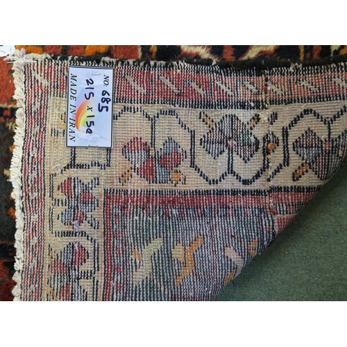 83 - A multicoloured Bakhtiari rug with panel design and white borders, 219cm x 149cm