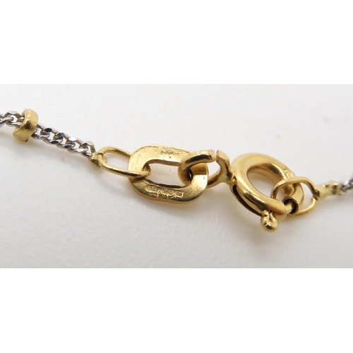 534 - An Italian made bi colour 18ct gold ball chain, length 50cm with a emerald and diamond cross, 3.4cm ... 