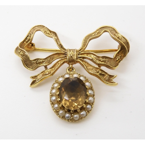 536 - A 9ct gold bow brooch set with smoky quartz and pearls, dimensions 3.5cm x 3.3cm, weight 7.8gms