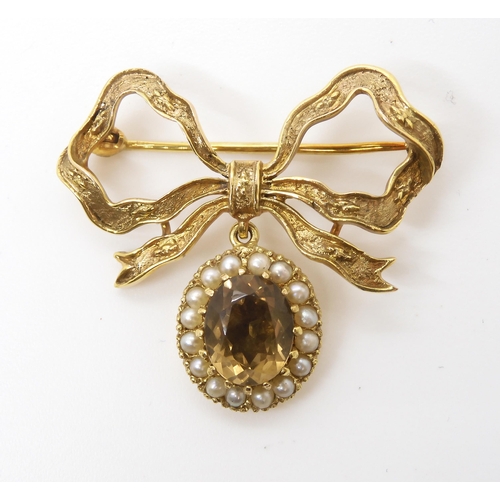 536 - A 9ct gold bow brooch set with smoky quartz and pearls, dimensions 3.5cm x 3.3cm, weight 7.8gms