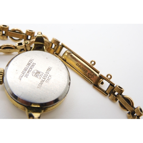 538 - A ladies gold plated Hugenin watch with a 9ct gold strap, weight approx of the strap 7gms