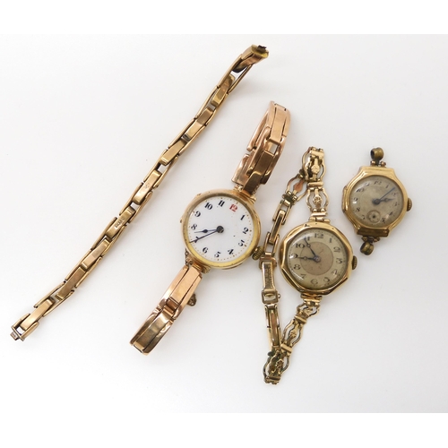 542 - A 9ct gold ladies vintage watch, two 9ct gold watch heads, and a 9ct strap, weight holding the gold ... 