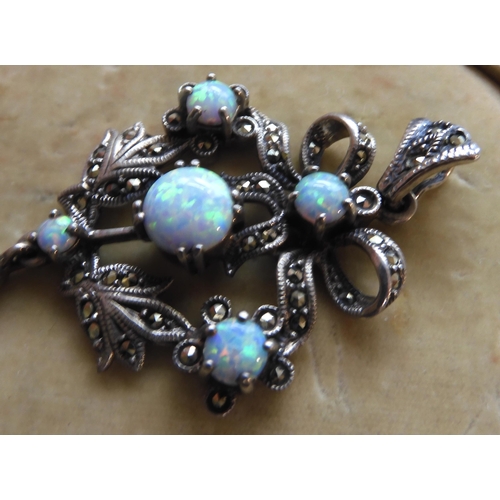 548 - A silver Victorian style imitation opal and marcasite pendant 7.4cm x 3.2cm, weight 11.2gms