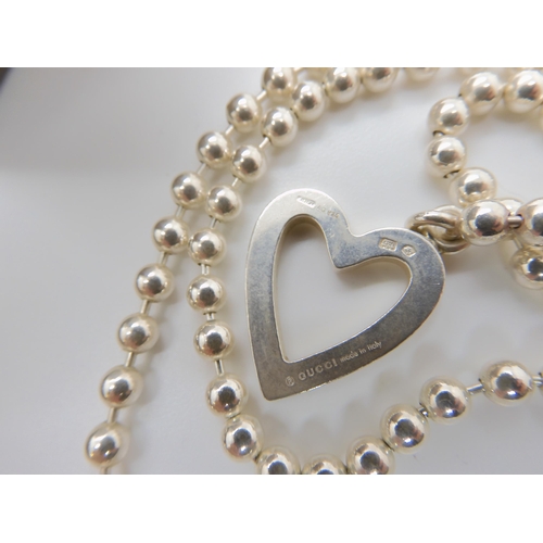 549 - A Gucci silver heart necklace, with ball chain, with full Gucci reg marks, Italian hallmarks and Swi... 