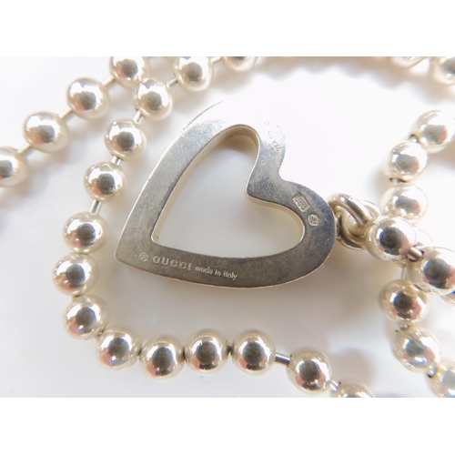 549 - A Gucci silver heart necklace, with ball chain, with full Gucci reg marks, Italian hallmarks and Swi... 