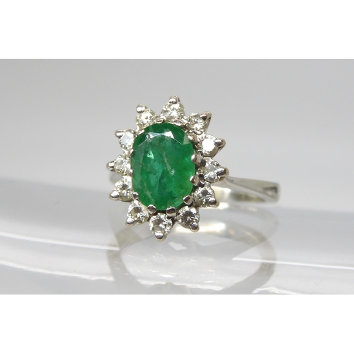 551 - A white metal emerald and diamond cluster ring, size F, set with estimated approx 0.20cts, together ... 