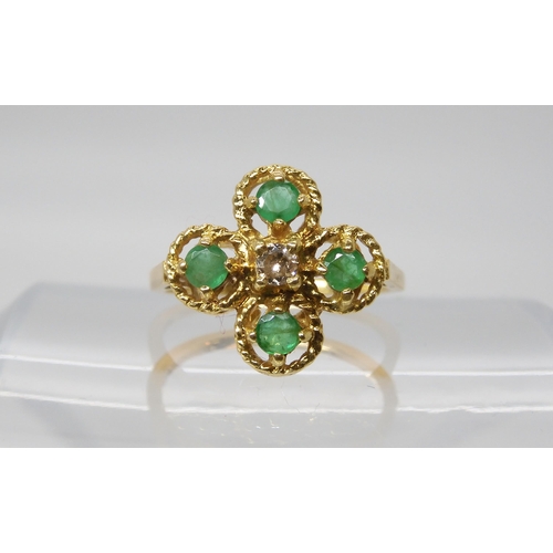 552 - An 18ct gold diamond and emerald flower ring, set with an estimated approx 0.08ct brilliant cut, fin... 