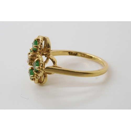 552 - An 18ct gold diamond and emerald flower ring, set with an estimated approx 0.08ct brilliant cut, fin... 