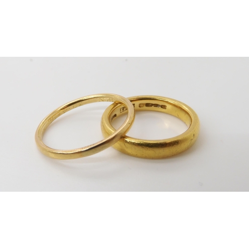 560 - A 22ct gold wedding ring with Birmingham hallmarks for 1870, size L, weight 6.7gms, together with a ... 