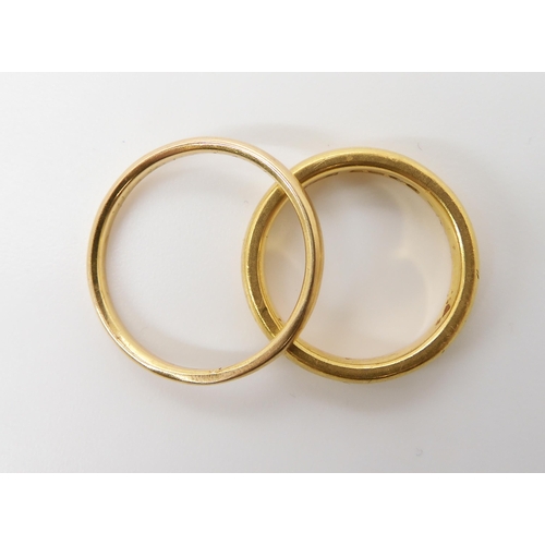 560 - A 22ct gold wedding ring with Birmingham hallmarks for 1870, size L, weight 6.7gms, together with a ... 