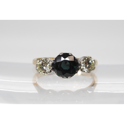 562 - An 18ct gold and platinum diamond and blue gem three stone ring, set with estimated approx 0.60cts o... 