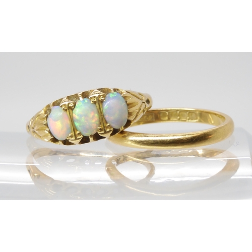 563 - An 18ct gold three opal ring., size P, together with an 18ct wedding ring size M, weight together 5.... 