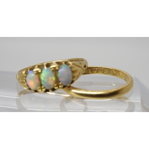 563 - An 18ct gold three opal ring., size P, together with an 18ct wedding ring size M, weight together 5.... 