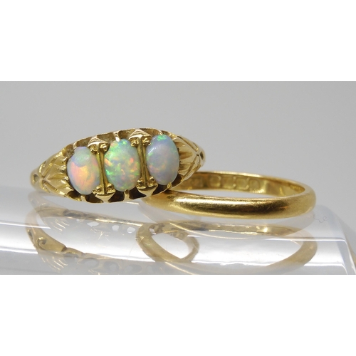 563 - An 18ct gold three opal ring., size P, together with an 18ct wedding ring size M, weight together 5.... 