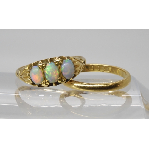 563 - An 18ct gold three opal ring., size P, together with an 18ct wedding ring size M, weight together 5.... 