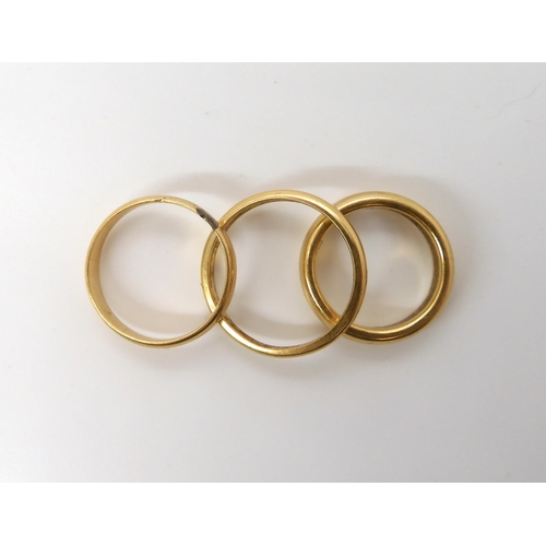 570 - A heavy weight ladies 18ct wedding ring, size J1/2, a gents 18ct wedding ring size R1/2, and a yello... 