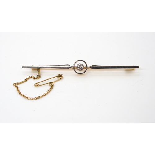 581 - A yellow and white metal Deco bar brooch set with an estimated approx 0.15ct old cut diamond, length... 