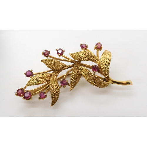 595 - A 9ct gold and ruby flower brooch weight 6.2gms, together with a silver Ola Gorie brooch