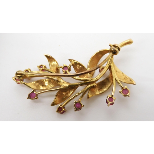 595 - A 9ct gold and ruby flower brooch weight 6.2gms, together with a silver Ola Gorie brooch