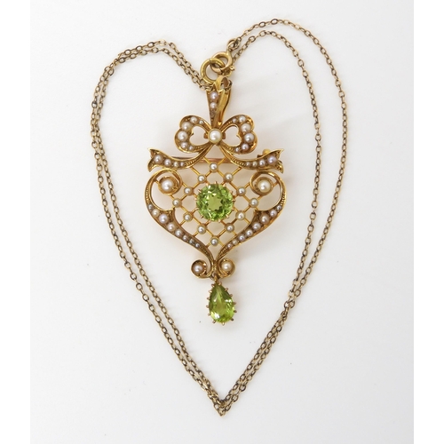 611 - A 15ct  gold peridot and pearl Edwardian pendant brooch, with a 9ct chain, weight combined 7.7g... 