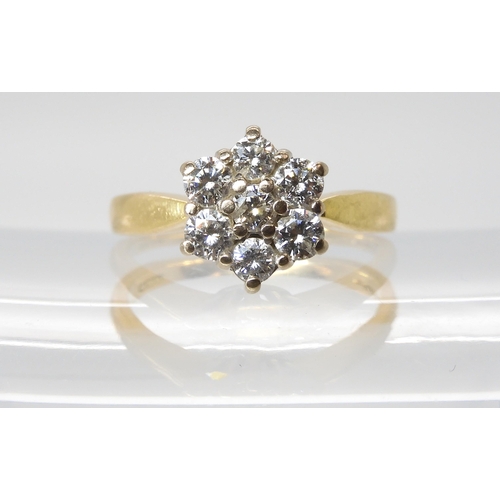 614 - An 18ct gold diamond flower ring set with estimated approx 0.70cts of brilliant cut diamonds, finger... 