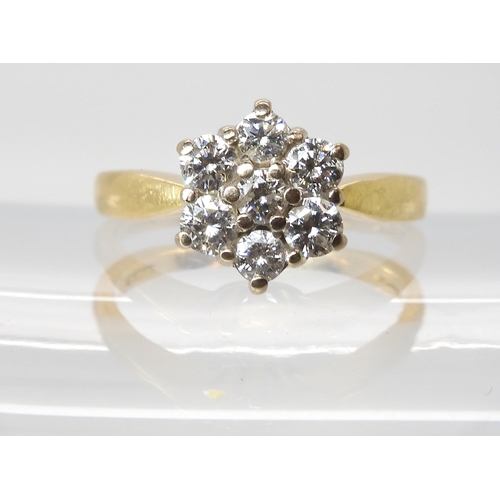 614 - An 18ct gold diamond flower ring set with estimated approx 0.70cts of brilliant cut diamonds, finger... 