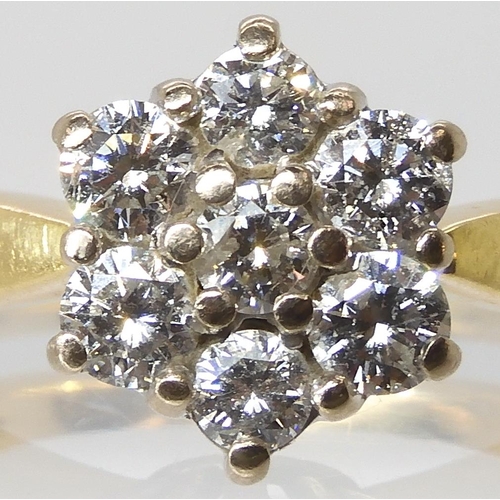 614 - An 18ct gold diamond flower ring set with estimated approx 0.70cts of brilliant cut diamonds, finger... 