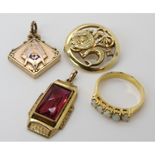 617 - A collection of gold plated items to include a Masonic pendant, a red gem set Deco pendant and other... 