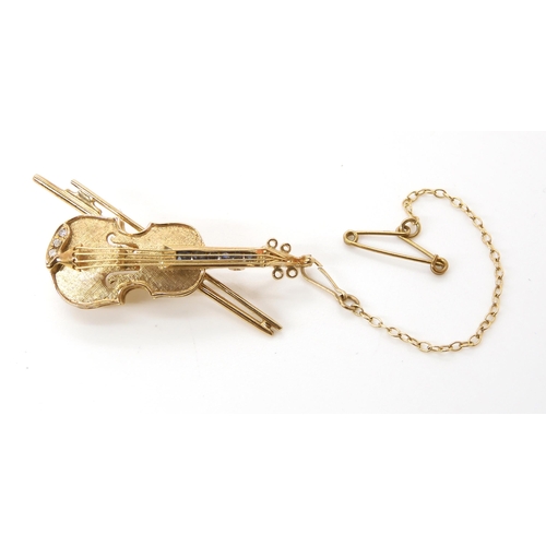 625 - A 9ct gold diamond and sapphire set violin brooch, dimensions 4cm x 2cm, weight 6.1gms