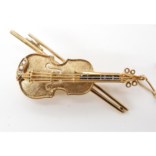 625 - A 9ct gold diamond and sapphire set violin brooch, dimensions 4cm x 2cm, weight 6.1gms