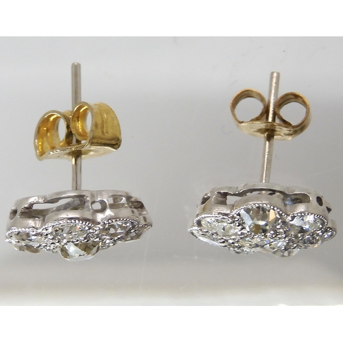 627 - A pair of white metal diamond flower earrings, set with estimated approx 1.60cts of old cut diamonds... 