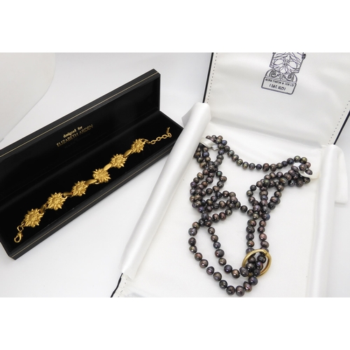 637 - A gold plated Elizabeth Arden Bracelet and a string of black pearls