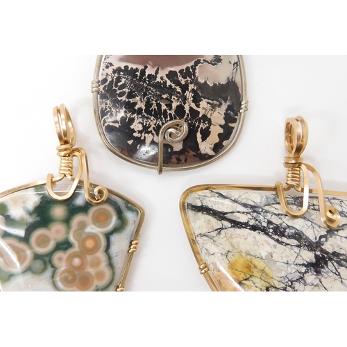 639 - Three American silver and gold plated wire wrapped mineral pendants to include marine jasper, and tw... 