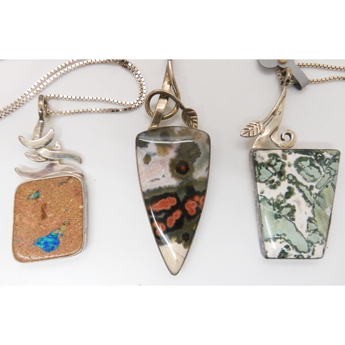 642 - Three American designer pendants made by Tom Burns, all three signed, two with silver chains, to inc... 