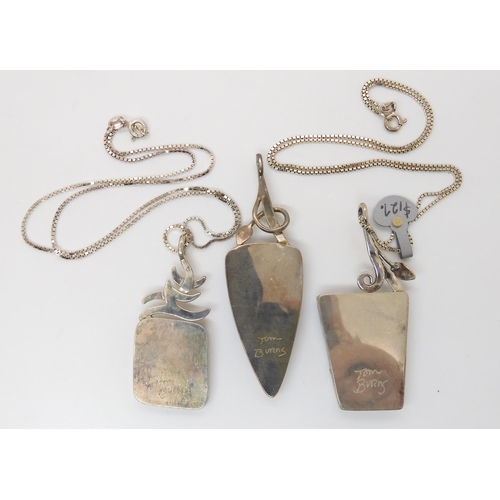 642 - Three American designer pendants made by Tom Burns, all three signed, two with silver chains, to inc... 