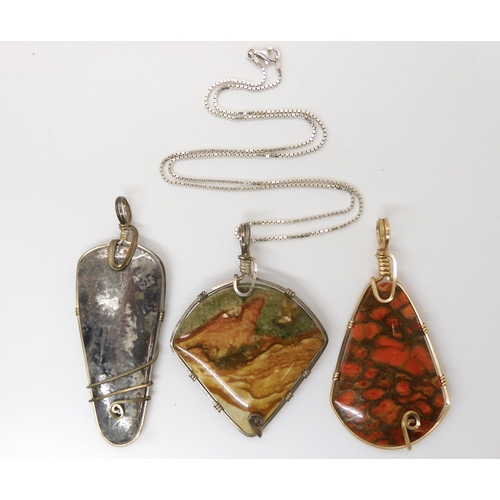 643 - Three American silver and gold plated wire wrapped mineral pendants to include pyrites, fossilized c... 