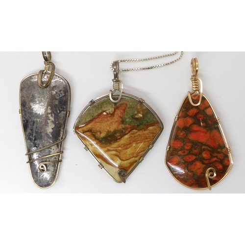 643 - Three American silver and gold plated wire wrapped mineral pendants to include pyrites, fossilized c... 