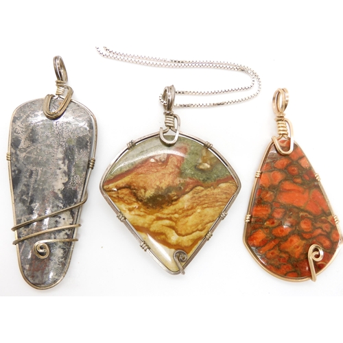 643 - Three American silver and gold plated wire wrapped mineral pendants to include pyrites, fossilized c... 