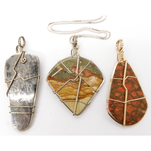 643 - Three American silver and gold plated wire wrapped mineral pendants to include pyrites, fossilized c... 